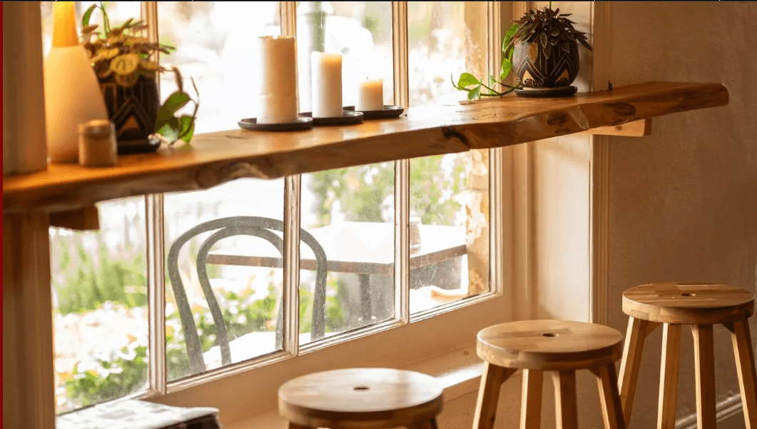 Timber bar stools at the window bench overlooking the garden at Cherry Bomb Cafe